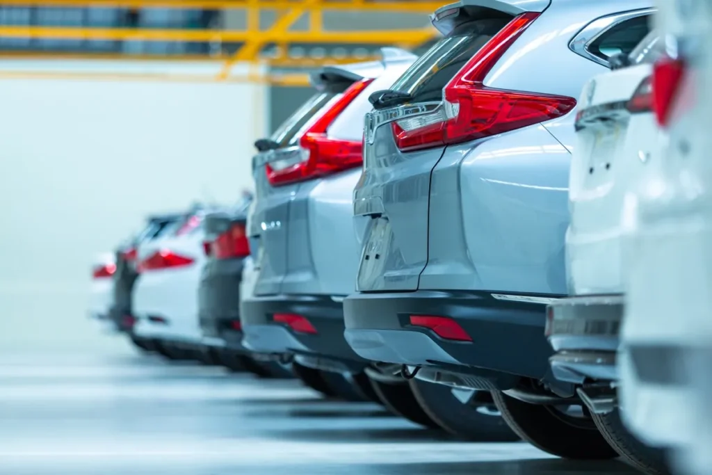 Rows of used cars for sale in a dealership parking lot