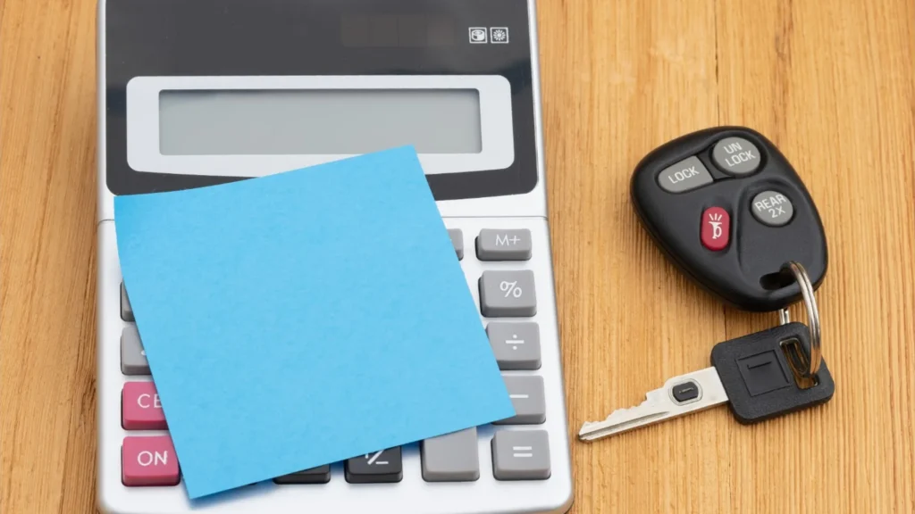 Vehicle title paperwork and car keys prepared for a Maine vehicle sale