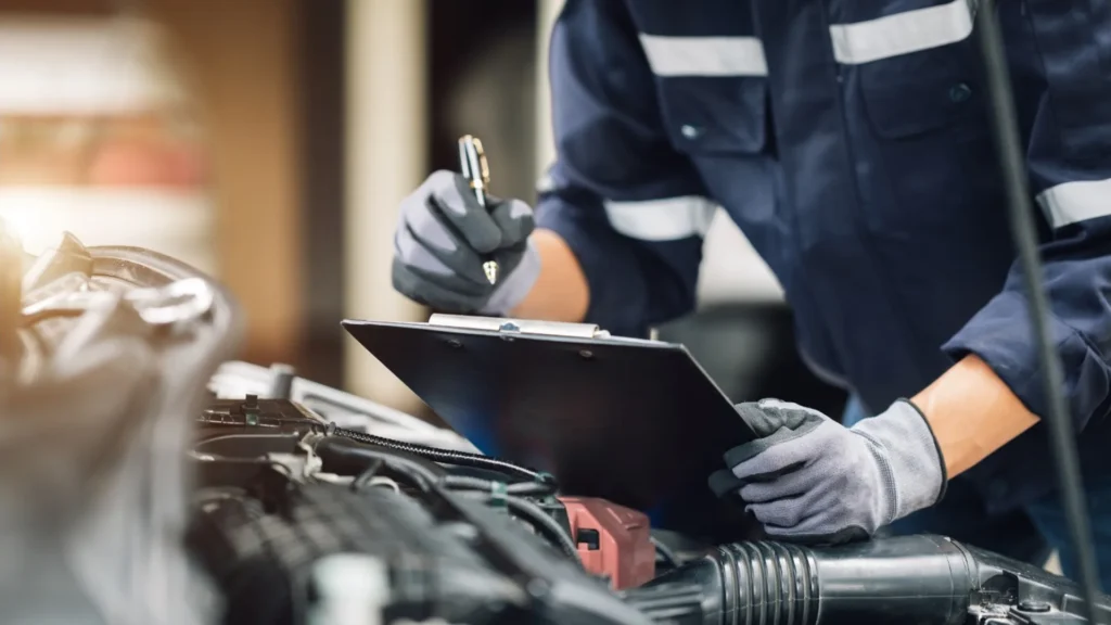 Older vehicle undergoing a failed safety inspection at a garage