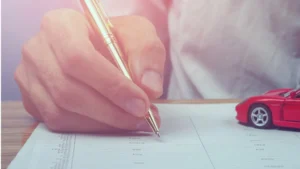 Vehicle title paperwork and car keys prepared for a Maine vehicle sale