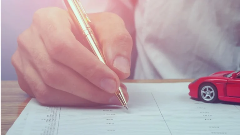 Vehicle title paperwork and car keys prepared for a Maine vehicle sale
