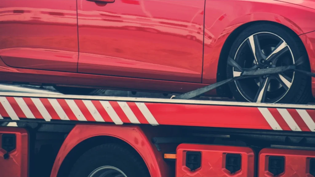 Locked older car being prepared for flatbed towing