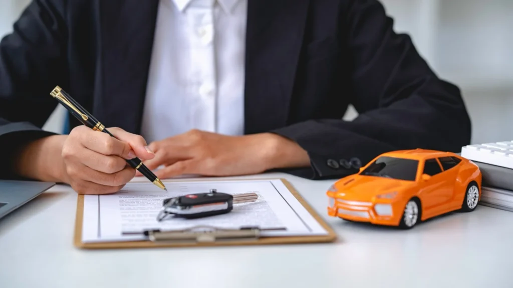 Vehicle title paperwork and car keys prepared for a Nevada vehicle sale