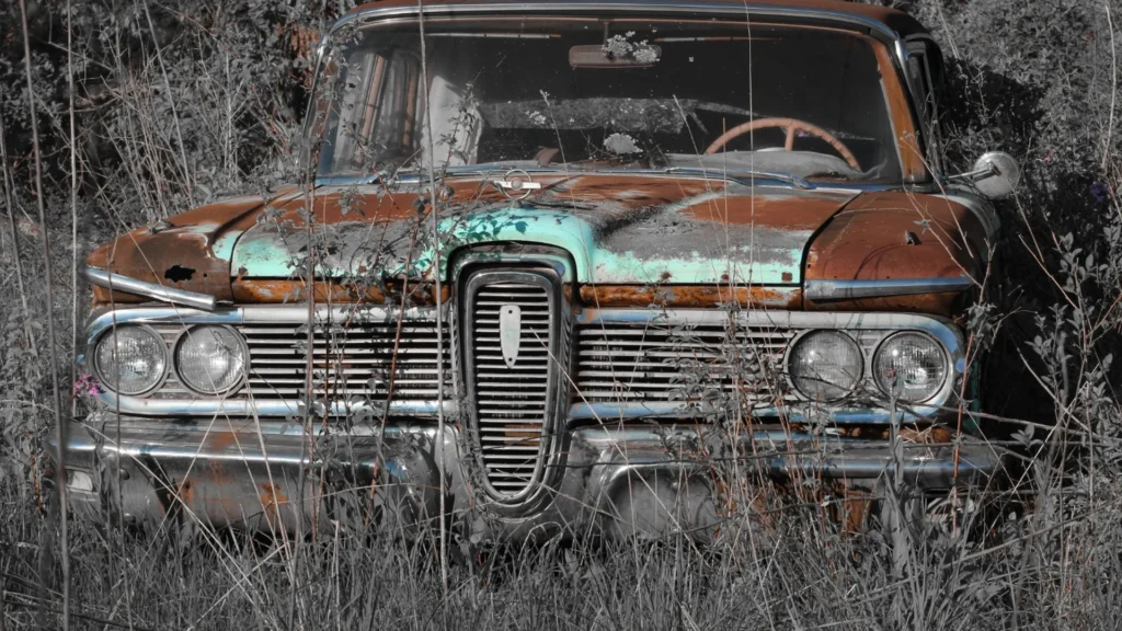 Heavily rusted older car in a snowy Nevada setting
