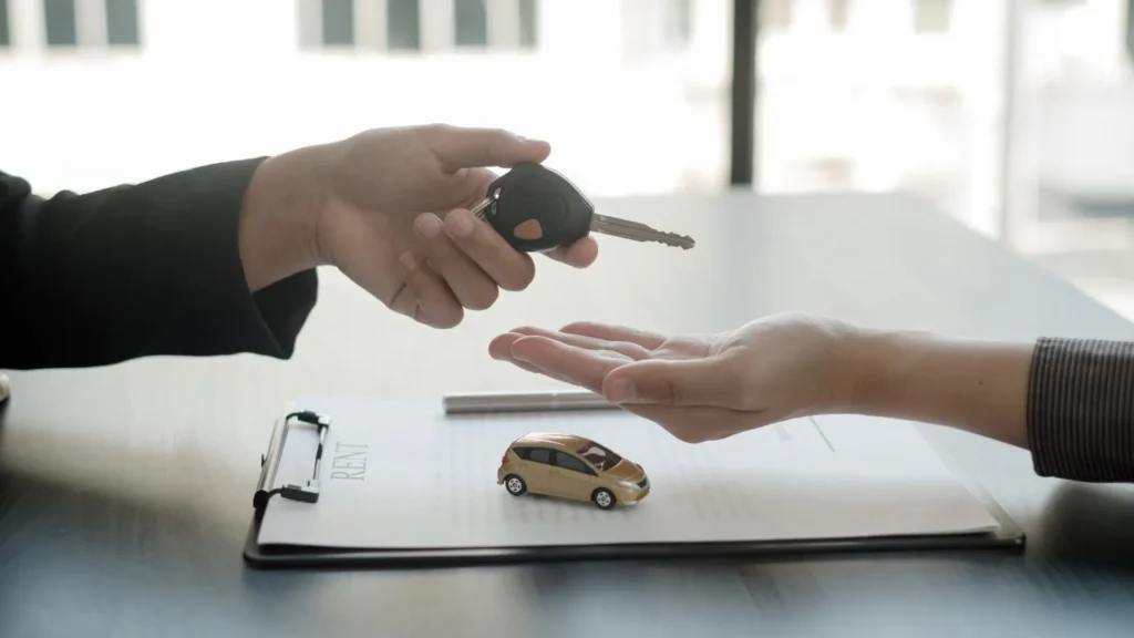 Vehicle title paperwork and car keys prepared for a Nevada vehicle sale