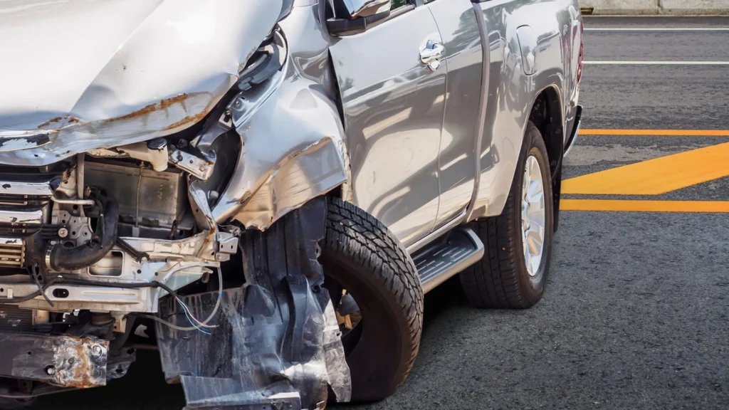 Older damaged car awaiting pickup in a northeastern community
