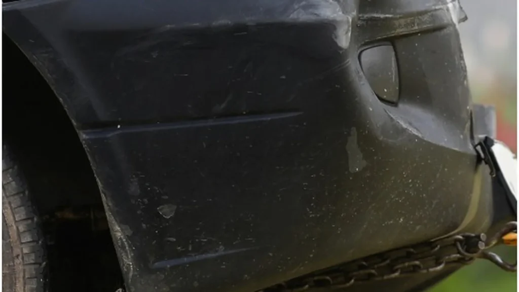 Older damaged car awaiting pickup in a northeastern community