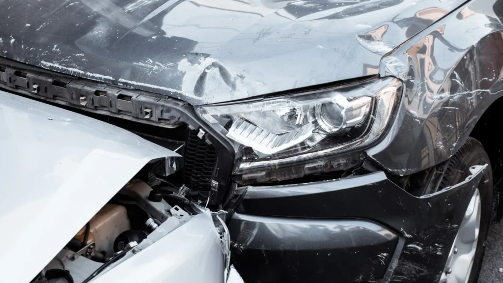 Car with front-end collision damage waiting for pickup