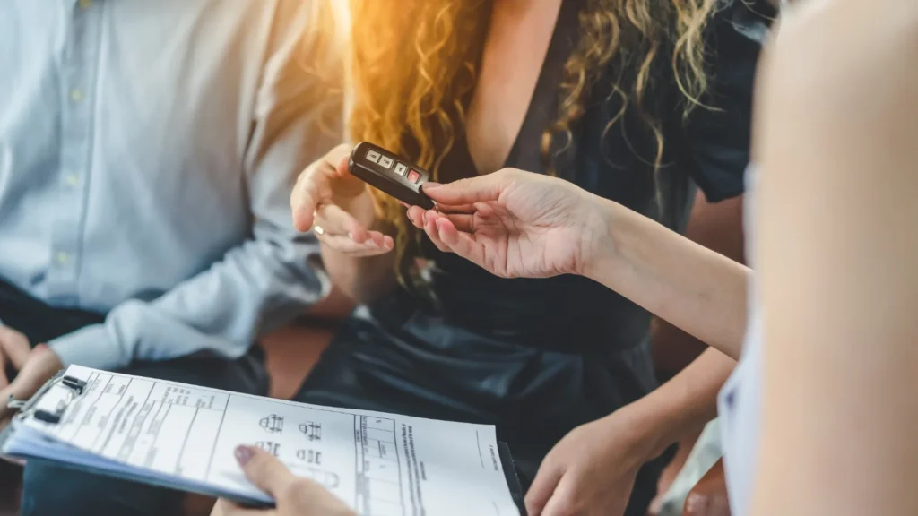 Vehicle title paperwork and car keys prepared for a Nevada vehicle sale