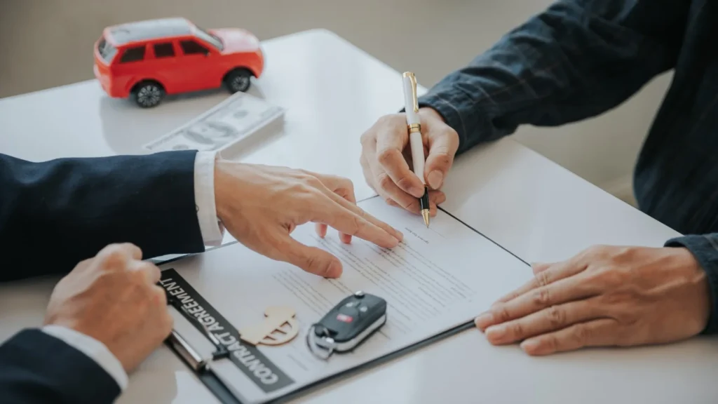 Vehicle title paperwork and car keys prepared for a Nevada vehicle sale