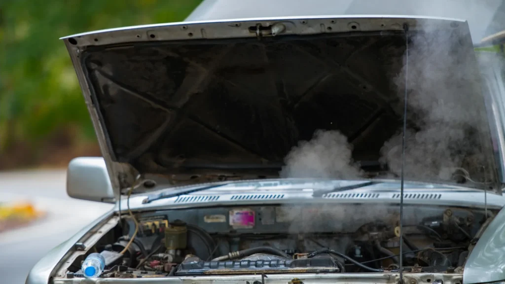Non-running car with its hood open awaiting a tow