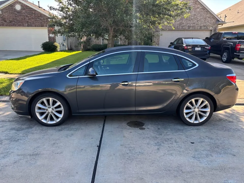 2012 Buick Verano sedan parked in a suburban Texas driveway before pickup
