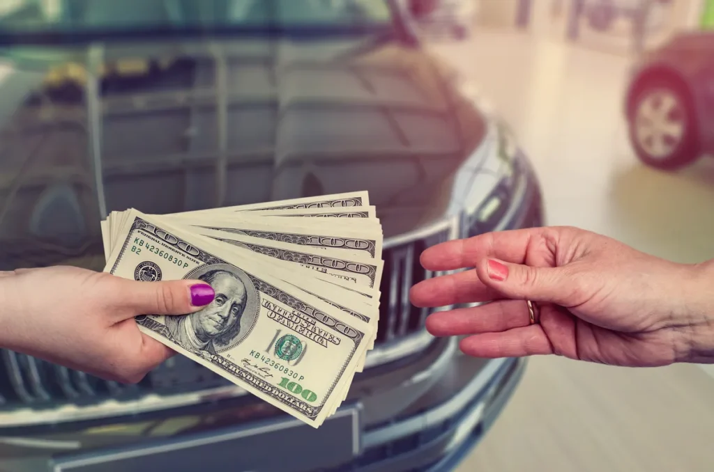 Buyer handing cash to a car seller in Pennsylvania