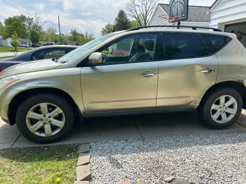 Side view of a gold 2007 Nissan Murano SV with visible body wear in Ohio