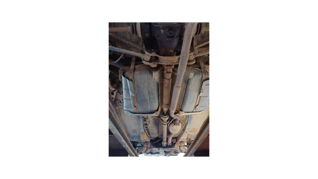 Catalytic Converter Scrap Value & Anti-Theft Laws in Ohio Bottom up view of a rusty old car's underside or undercarriage. Rusted underbody suspension and exhaust components, wide angle view, no