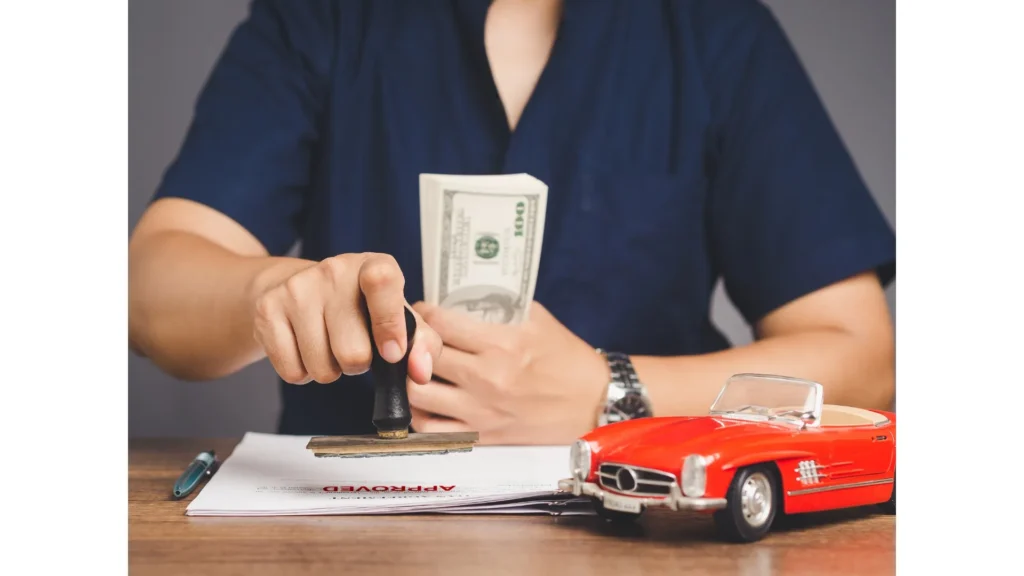 Businessman stamped the approved for car loan agreement while sitting at the table in the office