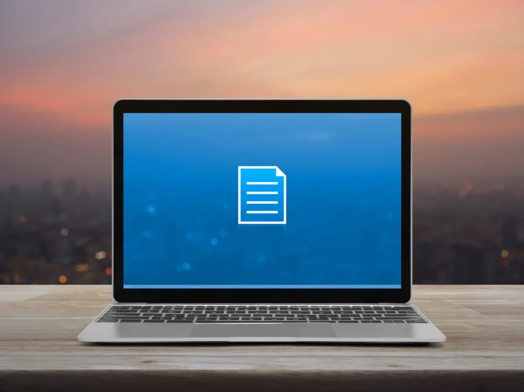 Laptop showing vehicle documents for online PennDOT services