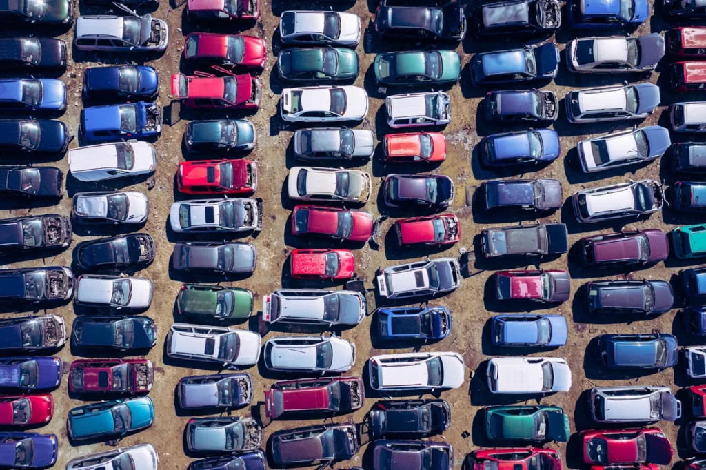 Aerial view of a scrap car yard where vehicles are recycled by weight