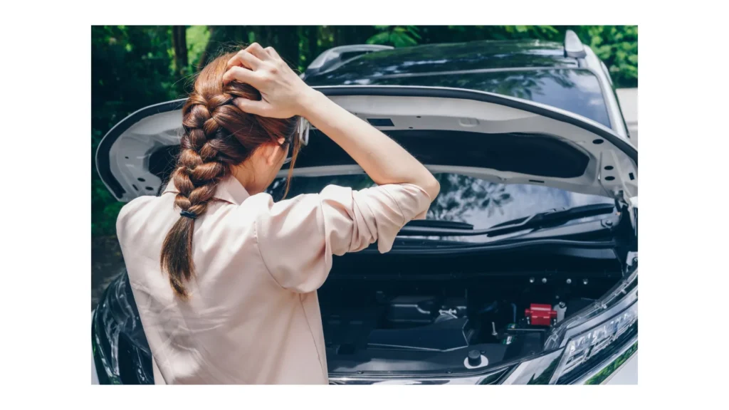 Asian woman opened car hood for looking the problem of car breakdown while waiting for assistance on the road side. Car breakdown it will
