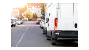 Small cargo delivery van parked in european city central district. Medium lorry minivan courier vehicle deliver package at residential