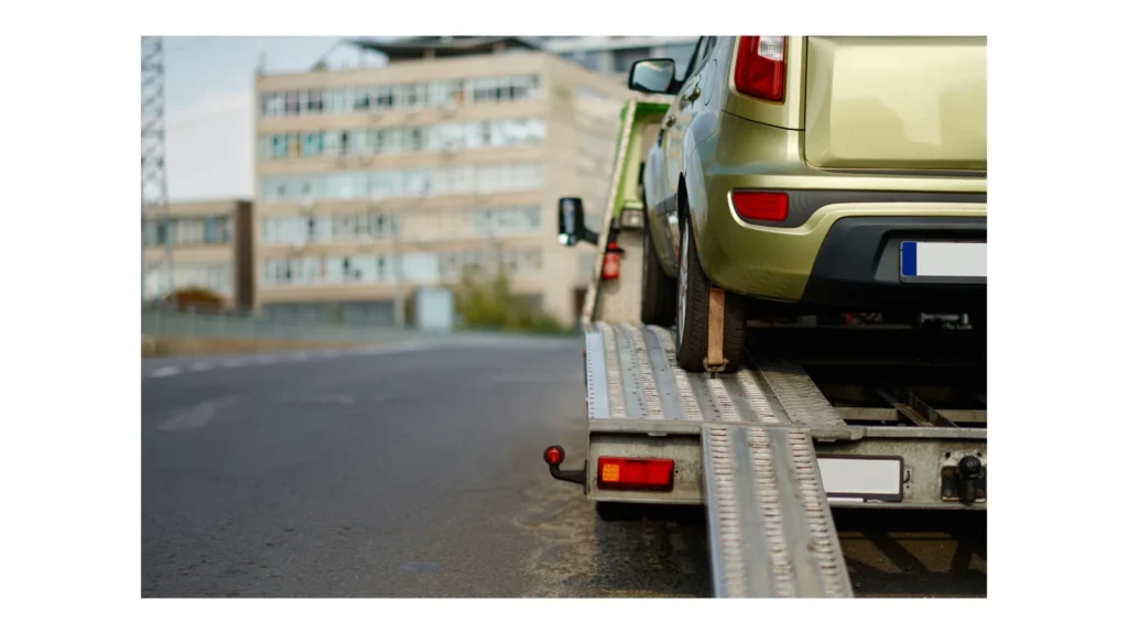 Broken car standing on flatbed tow truck