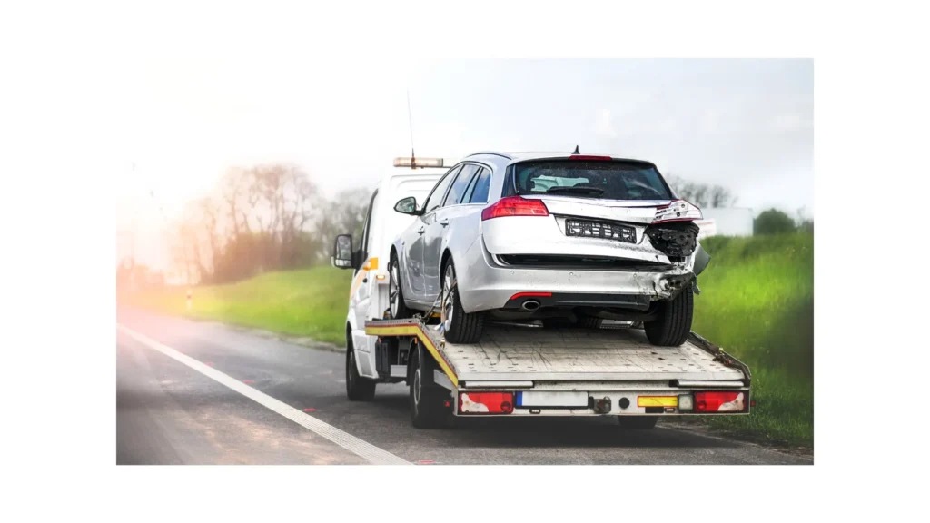 Loading broken car on a tow truck. Damage vehicle after crash accident on the highway road