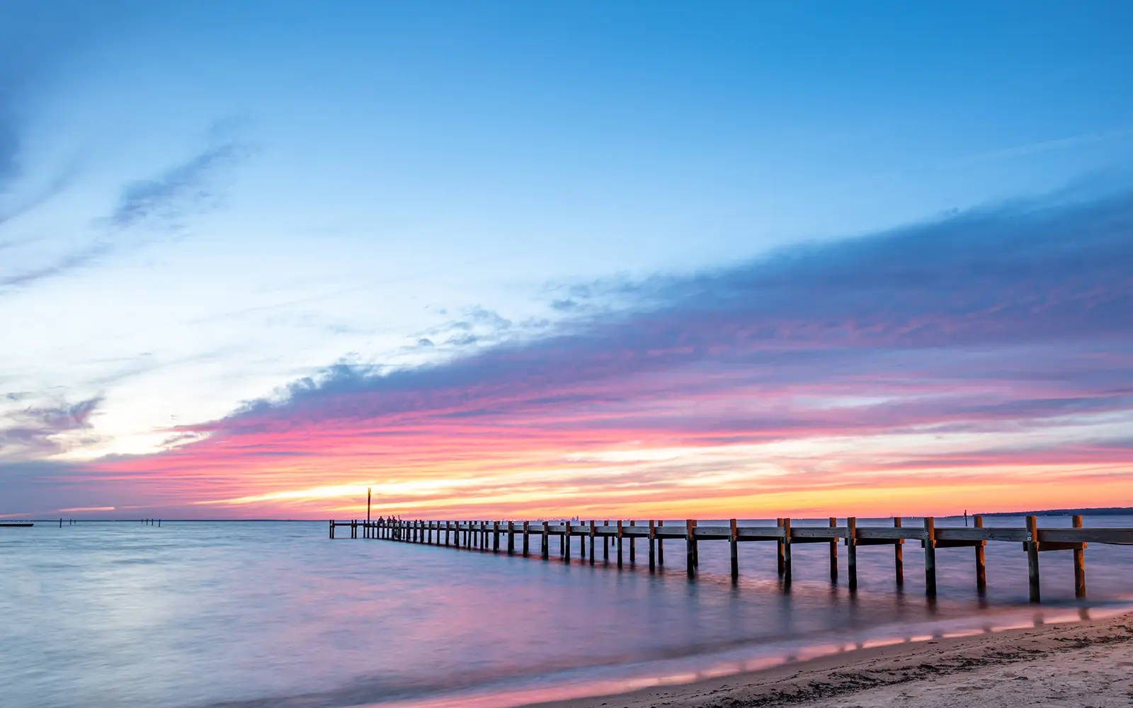 Fairhope pier on Mobile Bay at sunset – junk car removal in Baldwin County, Alabama